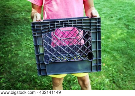 Teen boy holding a milk crate for the social media milk crate challenge