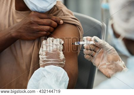Close-up Image Of Nurse In Protective Gloves Giving Shot Of Vaccine Against Covid-19 To Patient In M