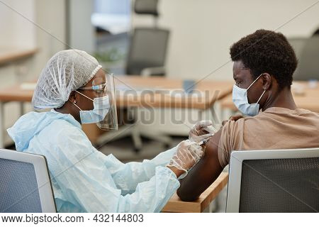 Scared Black Young Man Closing Eyes When Getting Shot Of Vaccine Against Coronavirus