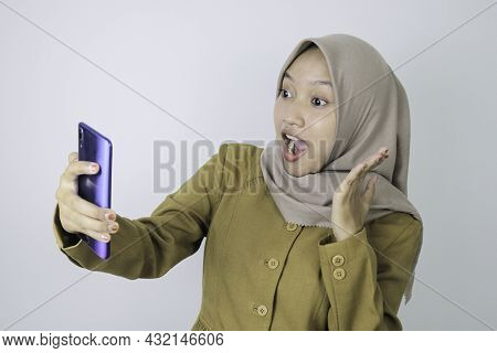 Shock Government Worker Women When Video Call Using A Smartphone. Pns Wearing Khaki Uniform.