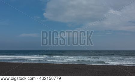 The Coast Of The Pacific Ocean. Surf Waves Foam On The Black Volcanic Sand Of The Khalaktyrsky Beach