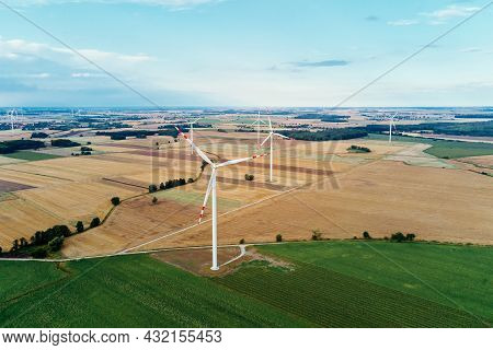 Windmill Among Agricultural Fields. Wind Turbine Generator At Summer Day. Wind Energy Concept, Suist