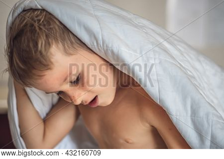 Close-up Side View Child Caucasian Boy Head Grey Hair Stick Out From White Blanket In Bedroom. Quali