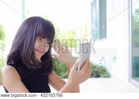 Woman Smile Calling Video Chat On Overlight Home Background. She Was Happily Chatting With Her Frien