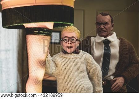 SEP 1 2021: recreation of a scene from 1983 movie A Christmas Story - Ralphie Parker, the Old Man and the Leg Lamp - Neca action figures