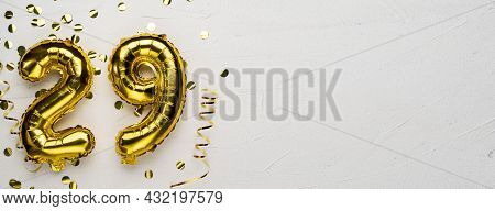 Golden Foil Balloon Number Twenty Nine. Birthday Or Anniversary Card With The Inscription 29. Gray C