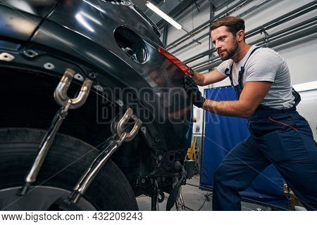 Man Is Pushing Car Taillight From Behind