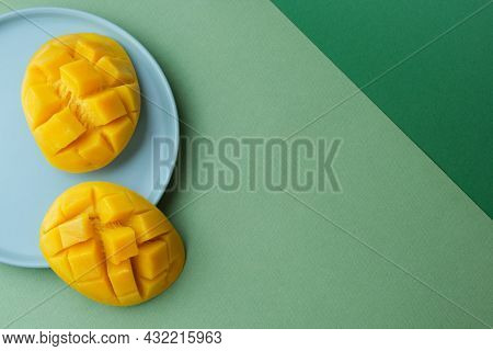 Creative Layout From Mango Ea Against Green Background. Flat Lay. Food Concept.