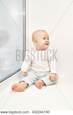 Cute Small Boy At House. Childhood Concept. Light Background. Smiling Child. Happy Emotion. Copyspac