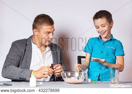 Chemistry Education And Training Concept. Close-up Of A Boy And His Dad Doing A Home Chemical Experi