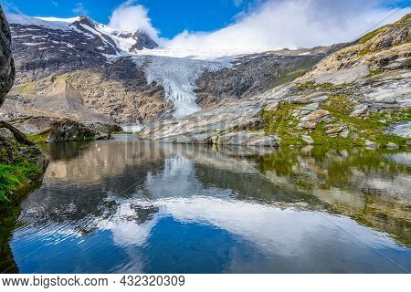 Mountain Glacier In Alpine Valley Reflected In Water. Schlaten Glacier, German: Schlatenkees, Hohe T