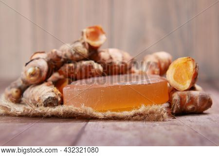 Turmeric Root And Herbal Soap On Table