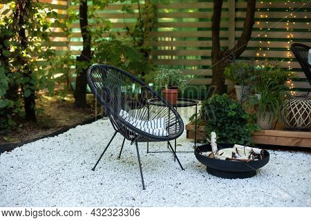 Outdoor Patio Furniture On Pebbles In A Front Garden. Front Veranda Of House With Two Black Acapulco