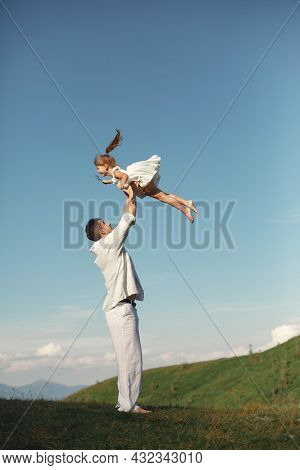 Father Playing With Ittle Daughter In A Mountains