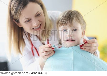 Little Cute Scared Girl Sitting In Chair At Dentist Closeup