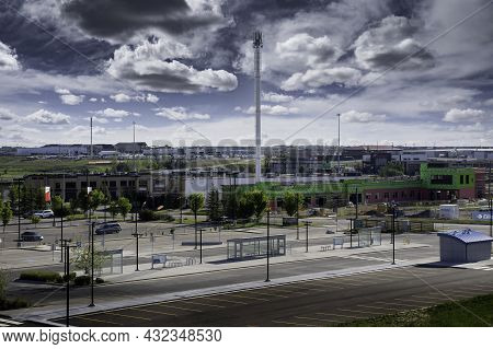 Airdrie Alberta Canada, August 31 2021: A Cell Phone Tower Stands Tall Next To A Public Transit Tran