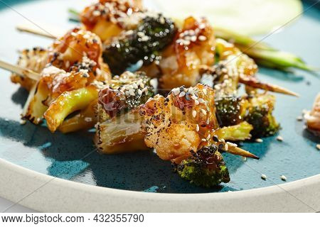 Vegetarian food - vegetables in skewers in teriyaki sauce. Grilled vegetables on bamboo stick in Japanese style. Vegan menu for asian restaurant. Eat less meat. Plant - based eating