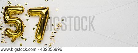 Golden Foil Balloon Number Fifty Seven. Birthday Or Anniversary Card With The Inscription 57. Gray C