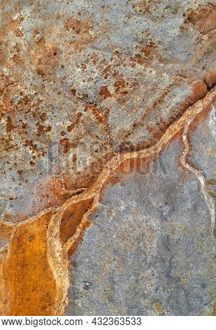 Dry Rusty River Bed Over Grey Mine Tailings, Acid Mine Drainage Vertical Texture