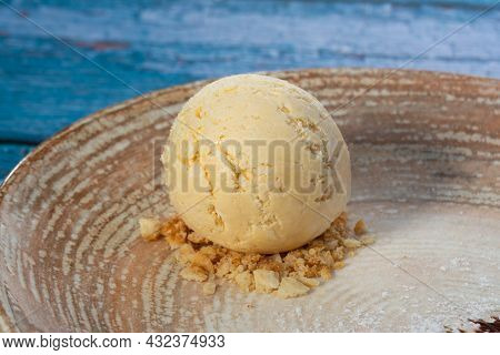 Scoop Of Vanilla Ice Cream And Almonds On A Plate
