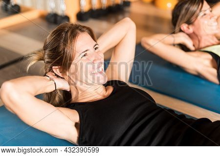 Close Up Of Cherrful Athlete Woman Doing Abs Exercise In Gym