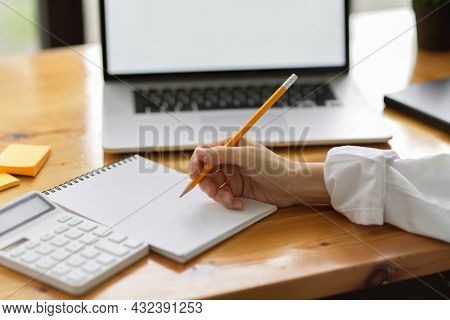 Close Up Female's Hand Writing On Notepads, Taking Notes On Paper, Calculating Monthly Expense