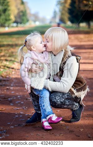 Scene Of Quiet Family Happiness And Love. Happy Caucasian Mother Holding Her Little Daughter On Her 