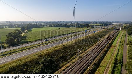 Motorway With Few Cars And Railroad Next To It, Near The Exit Of Brecht In Belgium, Europe. High Qua