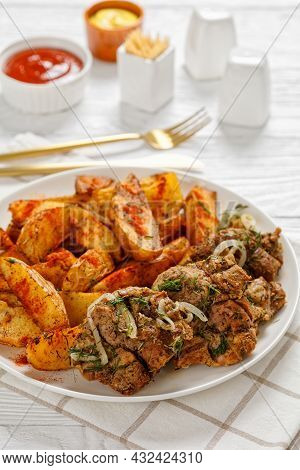 Grilled Pork Shoulder Steaks With Roasted Potato Wedges Seasoning With Paprika And Dill On A White P