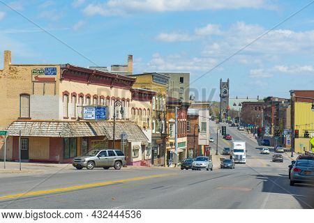 Malone, Ny, Usa - Apr. 29, 2017: Historic Sandstone And Brick Commercial Buildings With Italianate S