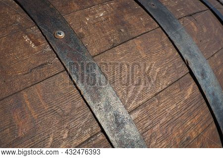 A Traditional Old Wooden Barrel With Curved Walls And Metal Hoops. Dishes For The Ripening Of Alcoho