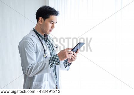 Asian Young Man Doctor Therapeutic Advising With Positive Emotions  Holding Up And Showing Digital T