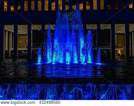 New York, Ny - 12/12/2021: A Water Fountain With Blue Light Illuminating In Water At Night In Front 