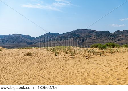 Picturesque Sarykum Dune. Sandy Mountain On The Background Of Mountains, The Caucasus. Dagestan, Rus