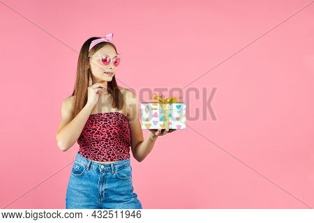 Young Smiling Happy Hipster Girl With Baces Holding Present Box Celebrating Party, Wearing Pink Sung