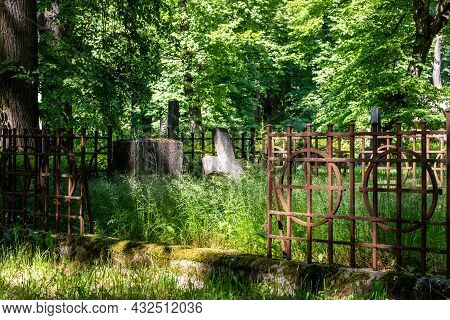 Churchyard Old Burial Ground And Fence In Graveyard Surrounded With Green Trees. Vintage Grave With 