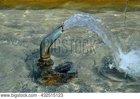 Swimming Pool With Fountains In The Shape Of An Opposite Cross On The Promenade In The Park On The S