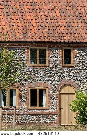 Traditional Flint Pebble Faced Cottage In Rural Norfolk Uk. Close-up Of A Beautifully Restored Old F