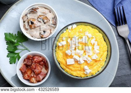 Tasty Banosh Served With Brynza, Pork Cracklings And Mushrooms On Dark Table, Flat Lay. Traditional 