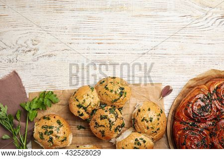 Traditional Ukrainian Bread (pampushky) With Garlic On White Wooden Table, Flat Lay. Space For Text