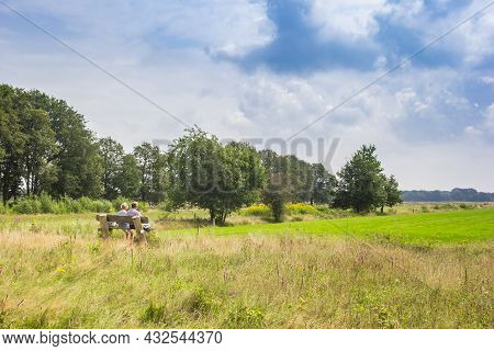 Couple Relaxing On A Bench At The Visitor Center Of National Park Dwingelderveld, Netherlands