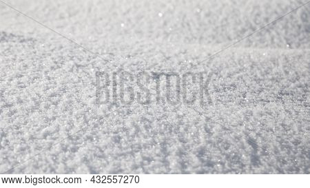 Smooth Surface Of Clean Fresh Snow. Snowy Ground. Winter Background With Snow Patterns. Closeup Top 