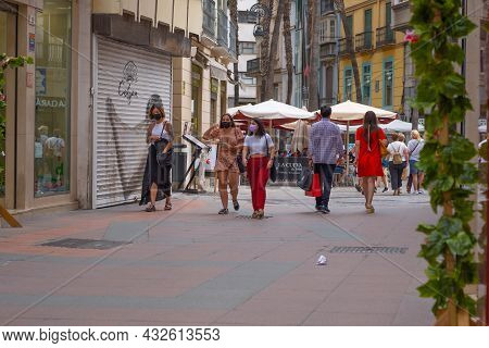 Málaga, Spain - June 19, 2021: People Walking In The Historic Center Of Malaga In Spain