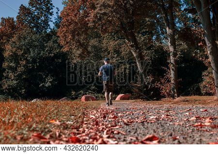 Spaarnwoude, The Netherlands, September 8, 2021 -  An Image Of A Man Walking Through A Park Wearing 