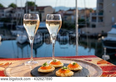 Russian Style Party With Two Glasses Of White Cold Champagne, Bliny With Red Caviar And View On Port