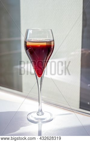 Drinking Of Kir Royal,  French Aperitif Cocktail Made  From Creme De Cassis Topped With Champagne, T