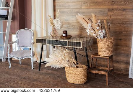 Cozy Design Room Home In Brown Tones: Wooden Table, Armchair, Wicker Baskets With Dried Flowers And 