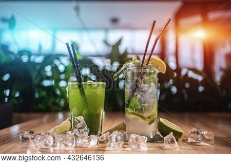 Mojito With Mint, Lime And Ice In Glass And Green Tarkhun Tarragon Drink In Cafe