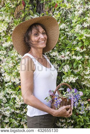 Woman With Wild Flower In Basket For Naturopathy And Botany