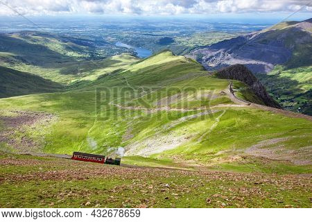 Mountain railway, Snowdonia, North Wales. The steam train runs from the town of LLanberis in the valley to the summit of Mount Snowden. Rural landscape in spring.